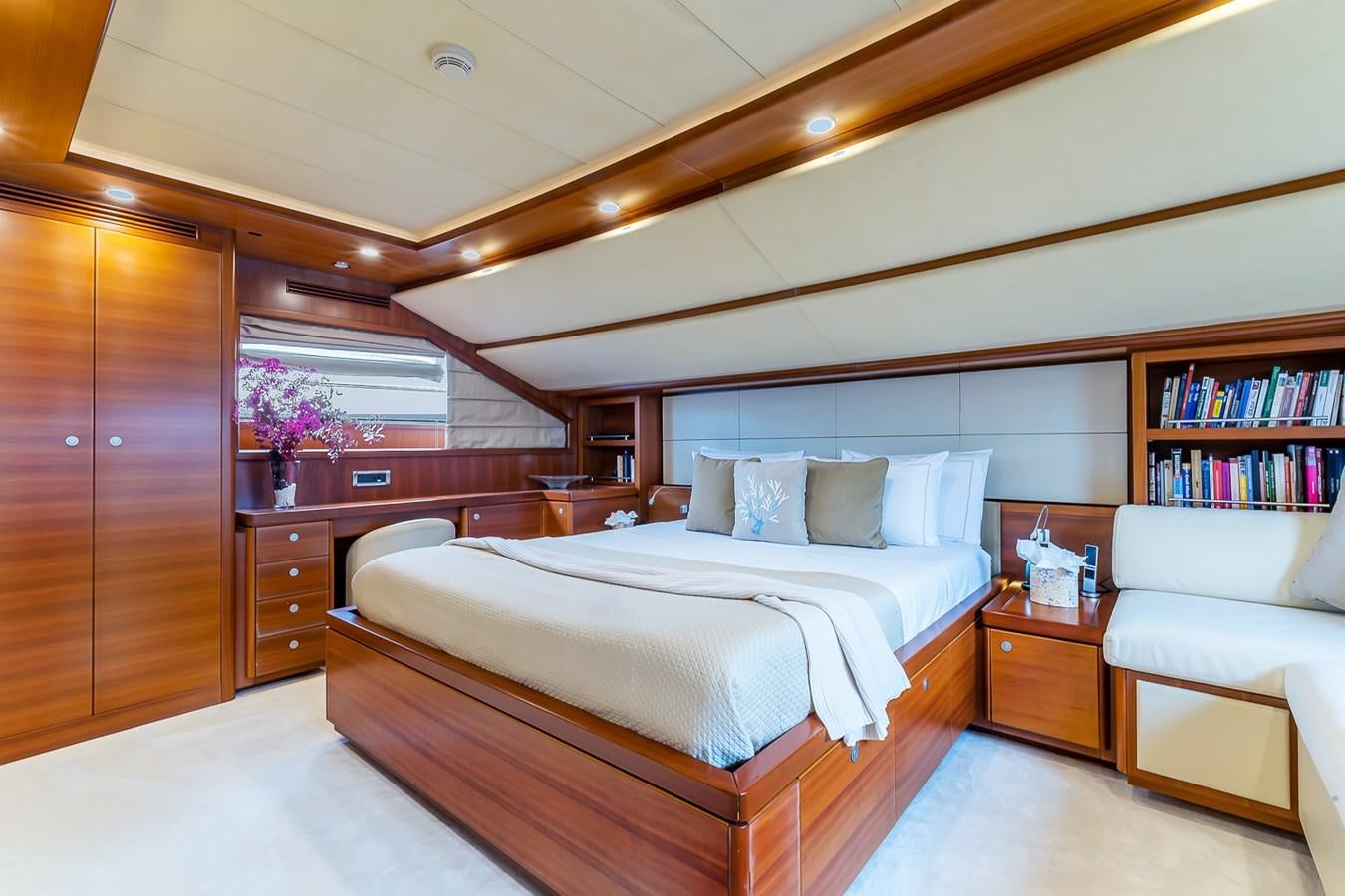 a bedroom with a bed and a bookcase aboard MALEN Yacht for Sale
