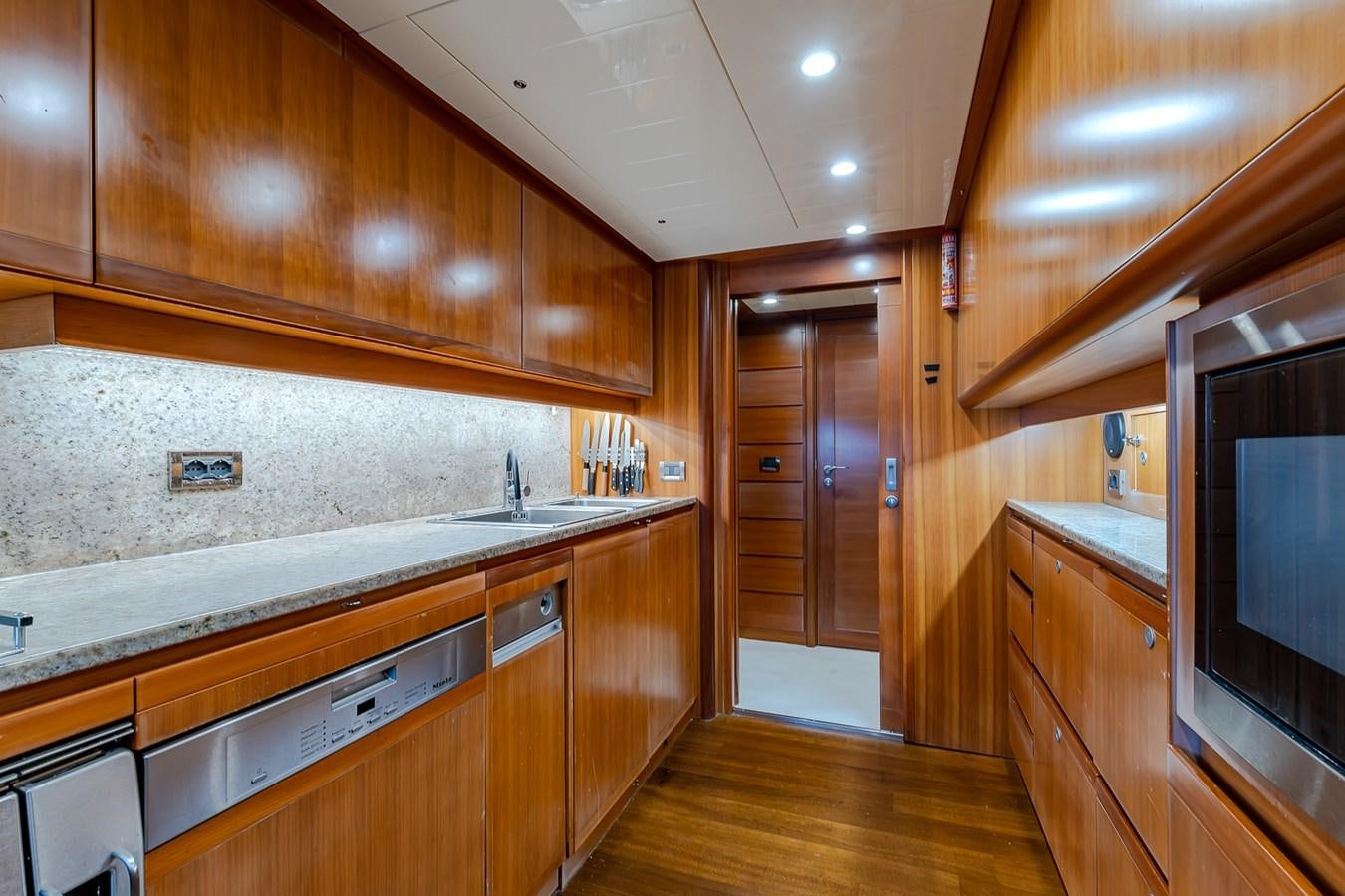 a kitchen with wooden cabinets aboard MALEN Yacht for Sale
