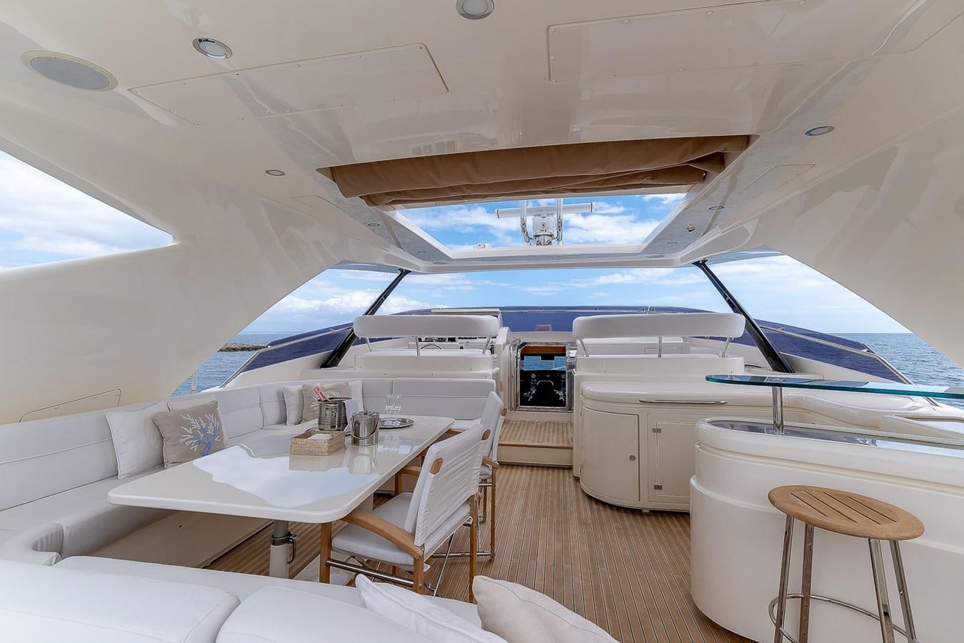 a room with a large bed and a table with chairs aboard MALEN Yacht for Sale