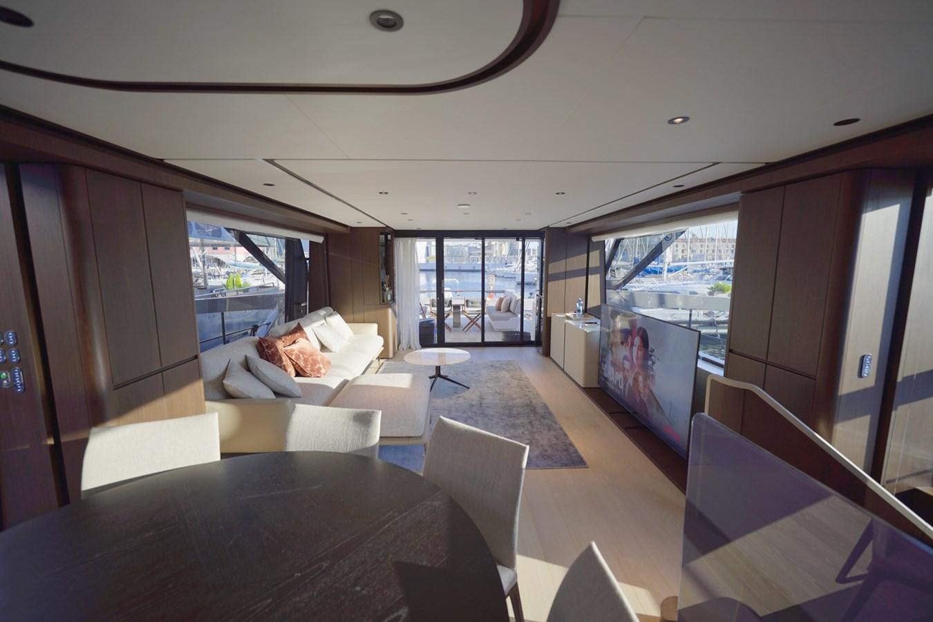 a room with a couch and a table and a large window aboard ASMARA Yacht for Sale