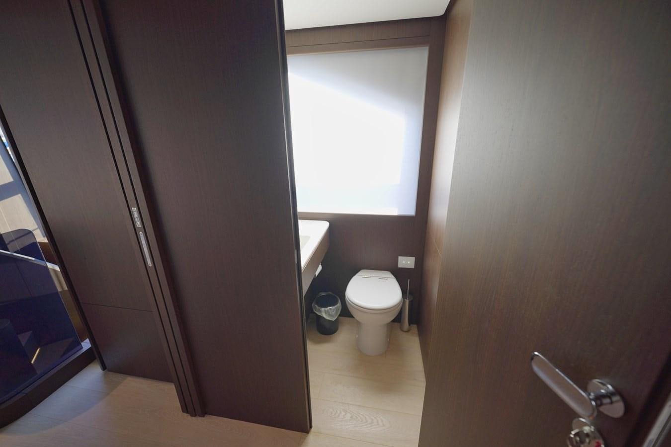 a bathroom with a toilet and a window aboard ASMARA Yacht for Sale