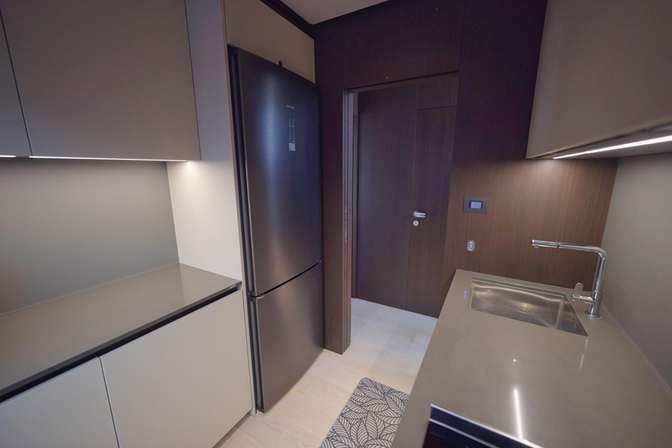 a kitchen with a stainless steel refrigerator aboard ASMARA Yacht for Sale