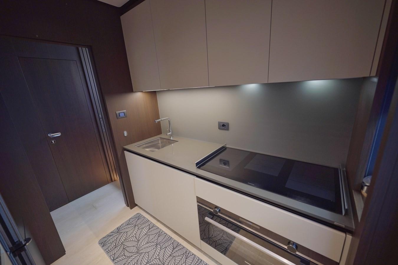 a kitchen with a black counter aboard ASMARA Yacht for Sale