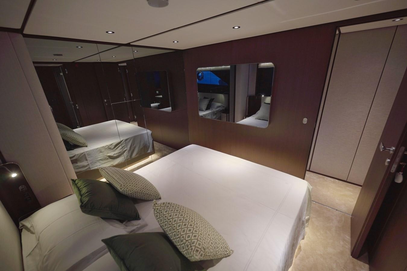 a room with a bed and a mirror aboard ASMARA Yacht for Sale