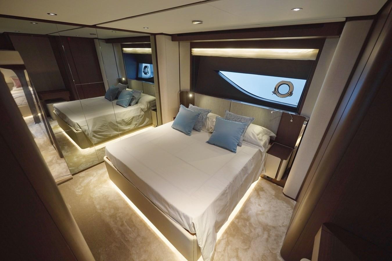 a hotel room with a bed and a mirror aboard ASMARA Yacht for Sale