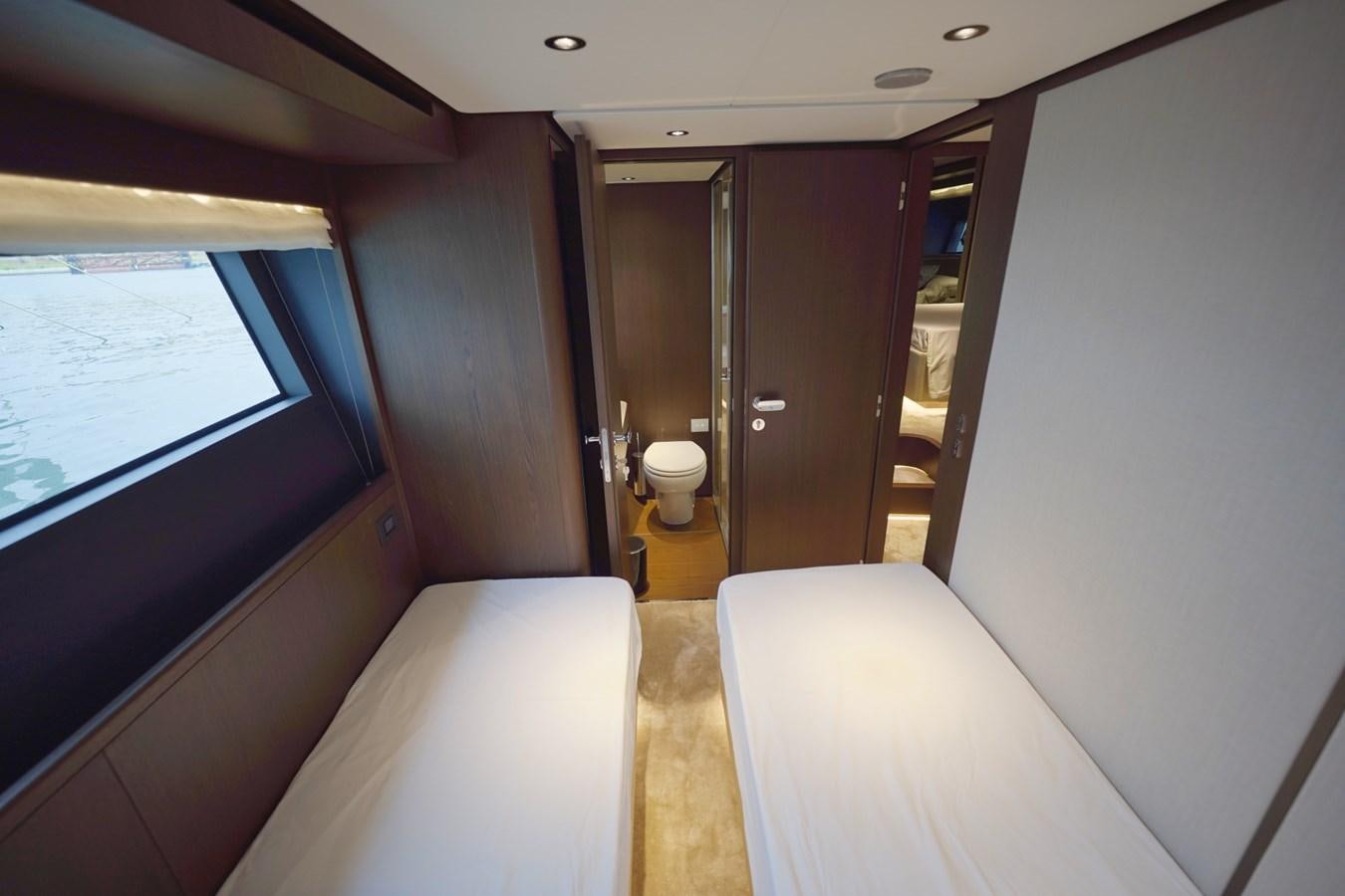 a room with a bed and a window aboard ASMARA Yacht for Sale