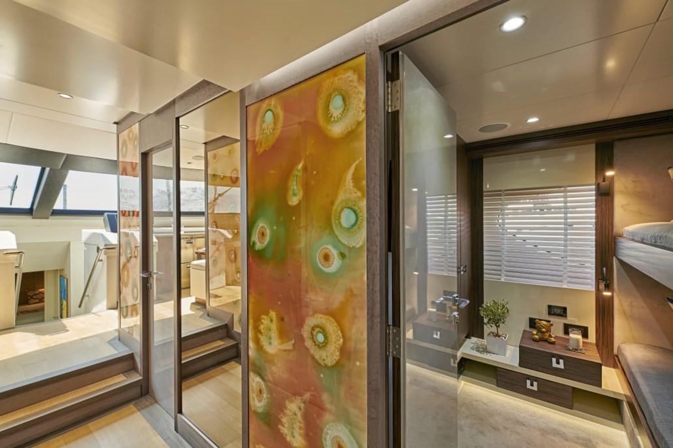 a large glass display case in a room with a large window aboard LA FENICE Yacht for Sale