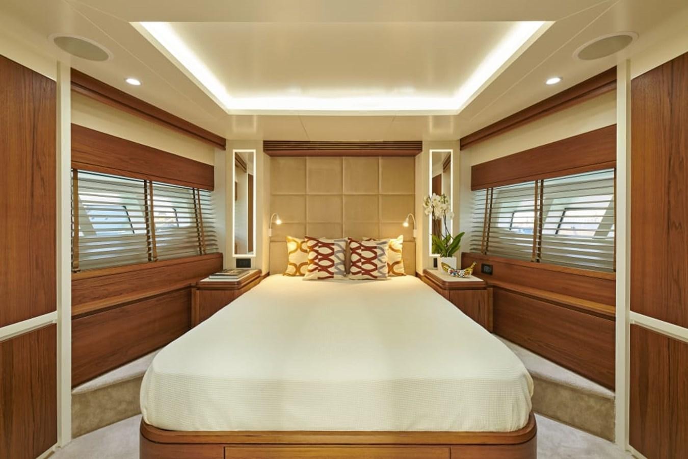 a bedroom with a bed and a window aboard LA FENICE Yacht for Sale