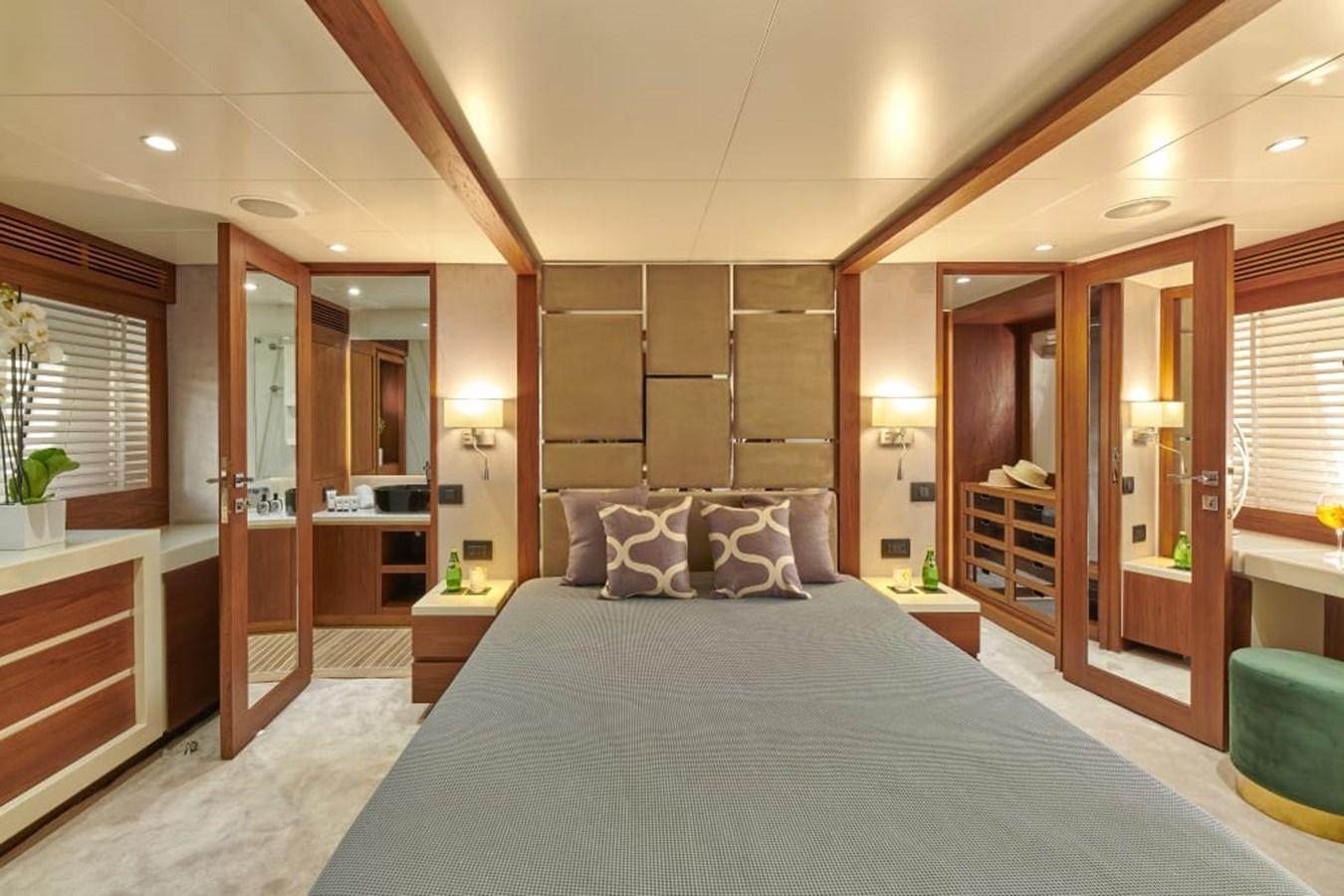 a large bedroom with a large bed aboard LA FENICE Yacht for Sale