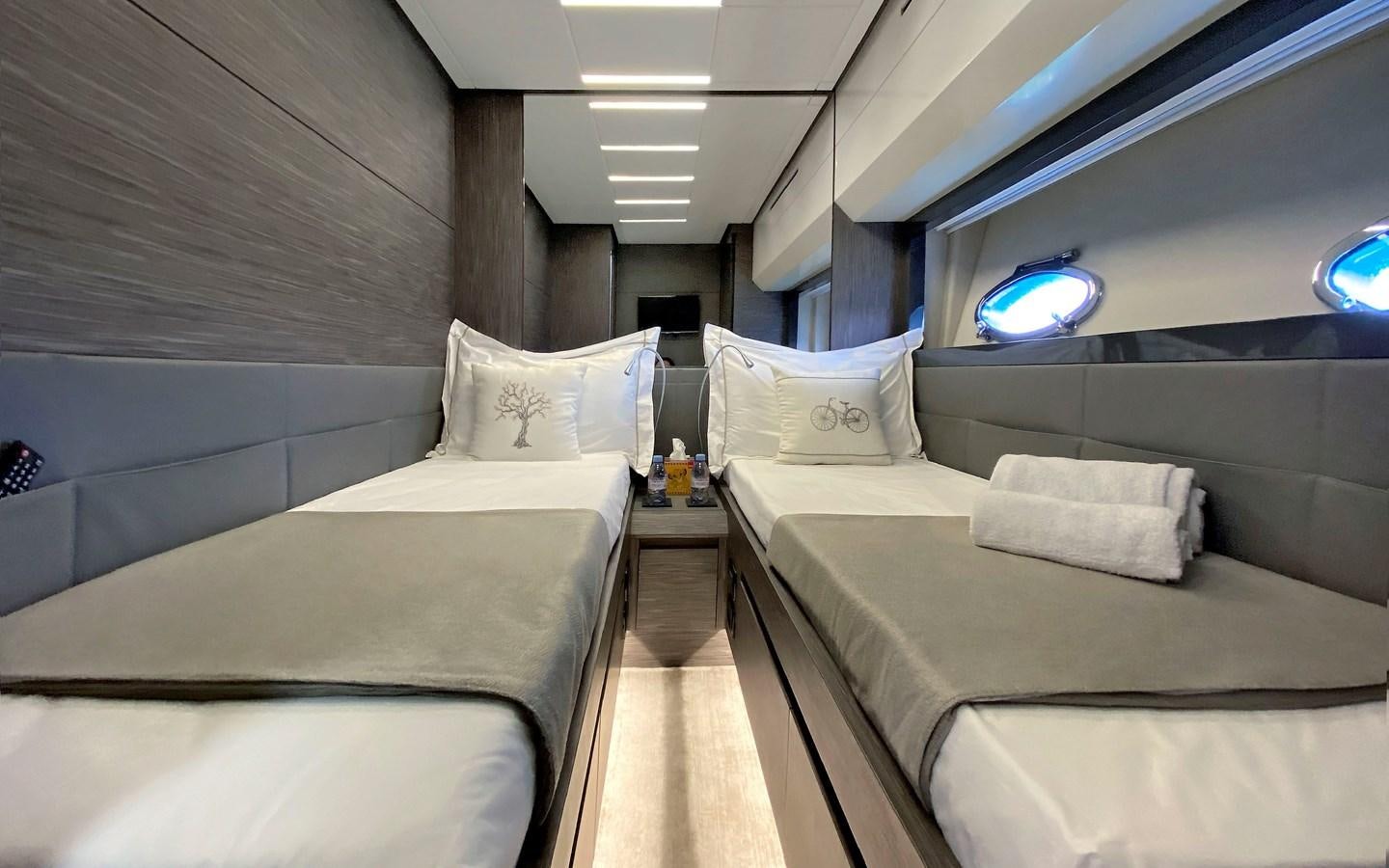 a room with beds and a window aboard UPTOWN GIRL Yacht for Sale