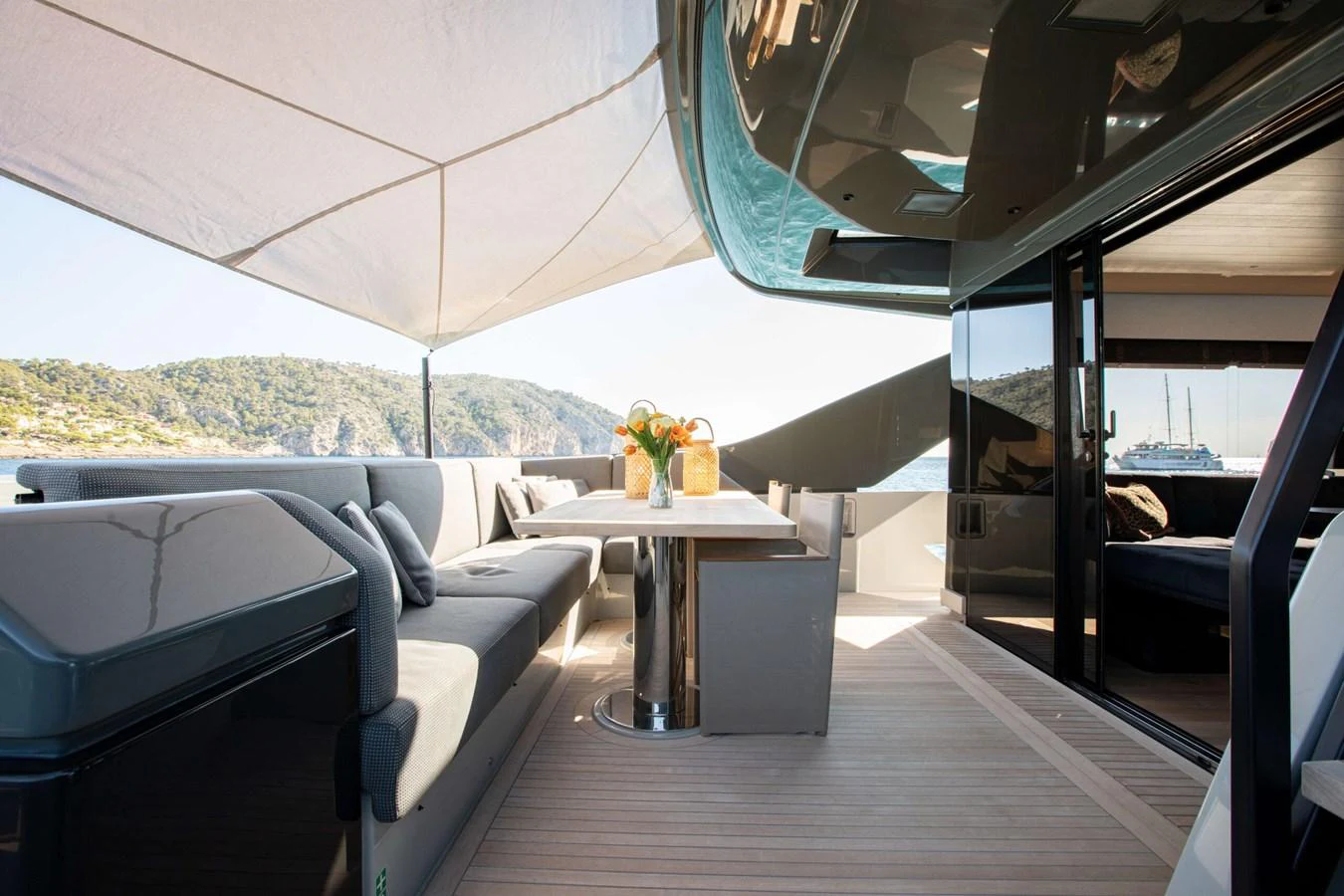 a room with a couch and a table aboard 2020 BLUEGAME BGX70 #02 Yacht for Sale