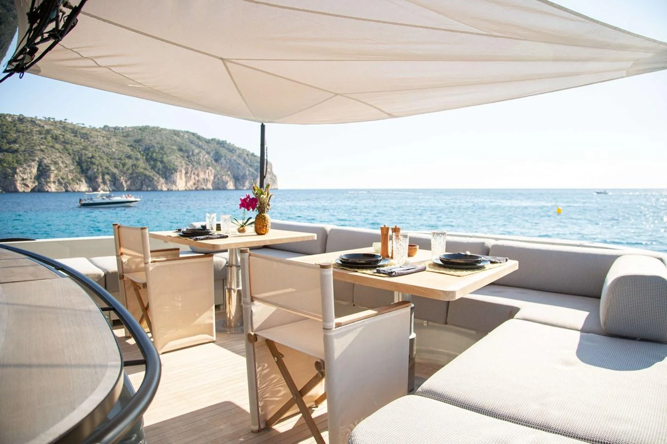 a table and chairs on a boat aboard 2020 BLUEGAME BGX70 #02 Yacht for Sale