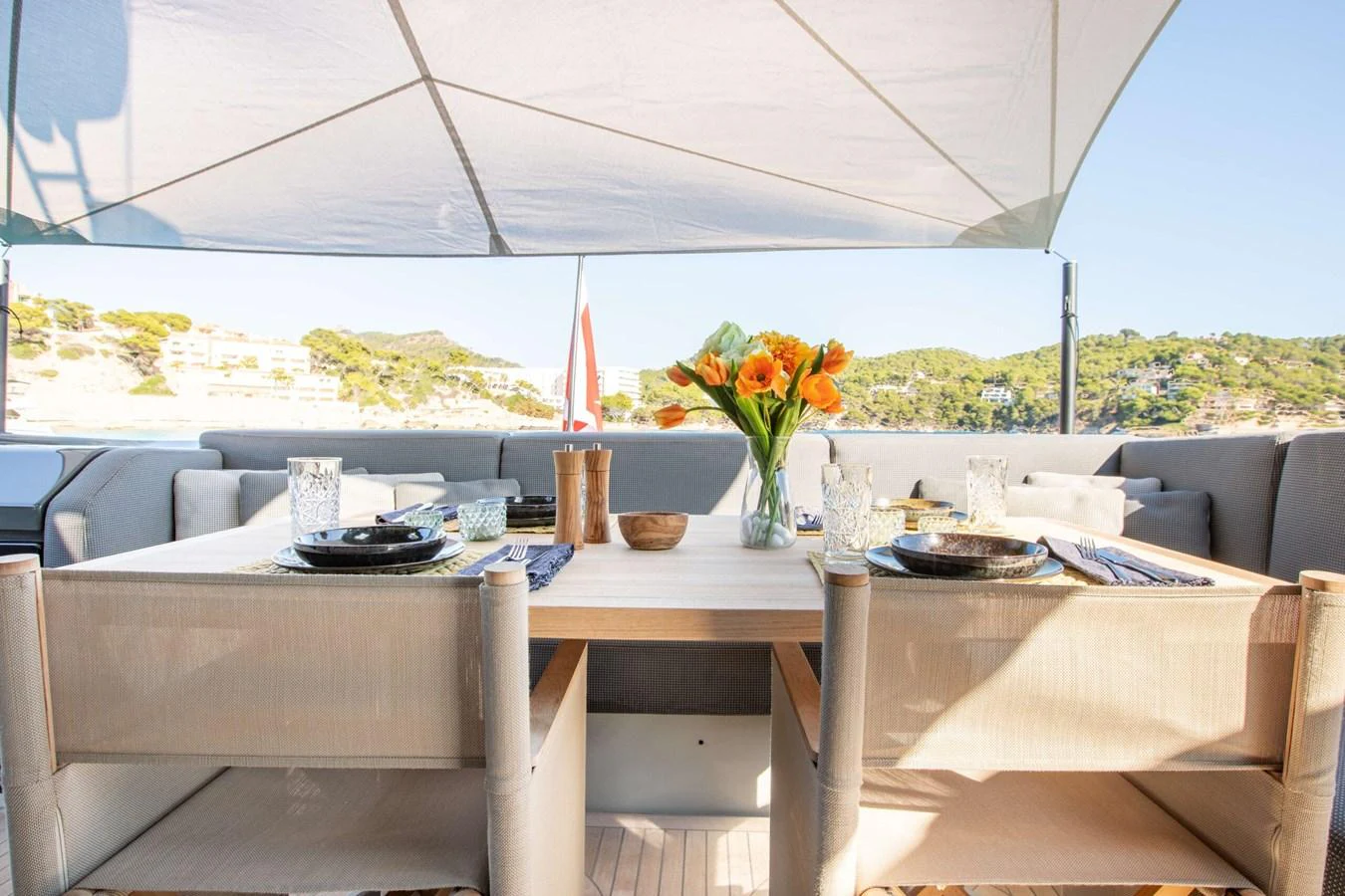 a table with plates and glasses on it aboard 2020 BLUEGAME BGX70 #02 Yacht for Sale