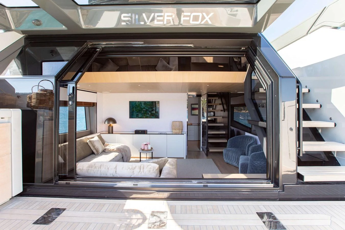 a train with a couch and a coffee table aboard 2020 BLUEGAME BGX70 #02 Yacht for Sale