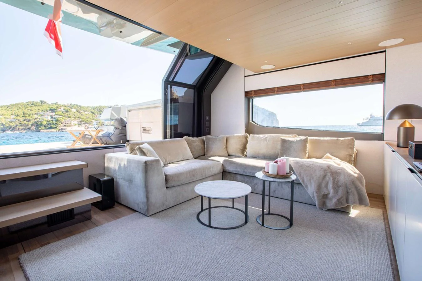 a living room with a large window aboard 2020 BLUEGAME BGX70 #02 Yacht for Sale