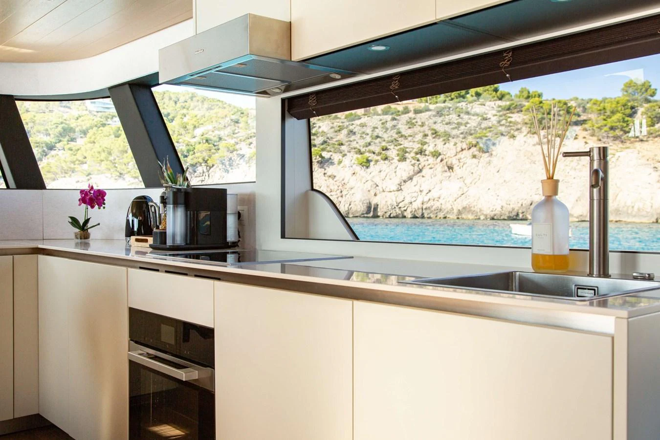 a kitchen with a pool aboard 2020 BLUEGAME BGX70 #02 Yacht for Sale