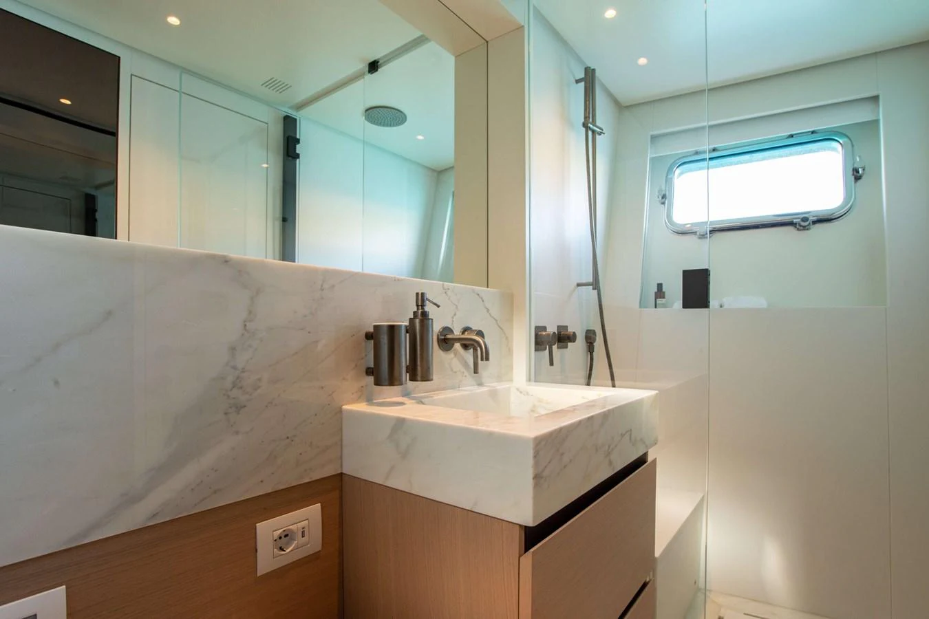 a bathroom with a large mirror aboard 2020 BLUEGAME BGX70 #02 Yacht for Sale
