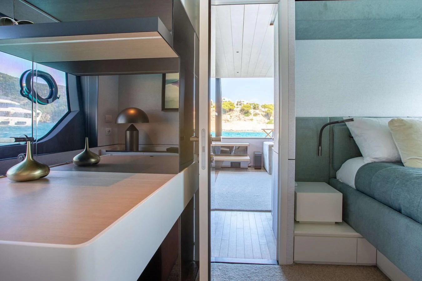 a room with a couch and a window aboard 2020 BLUEGAME BGX70 #02 Yacht for Sale