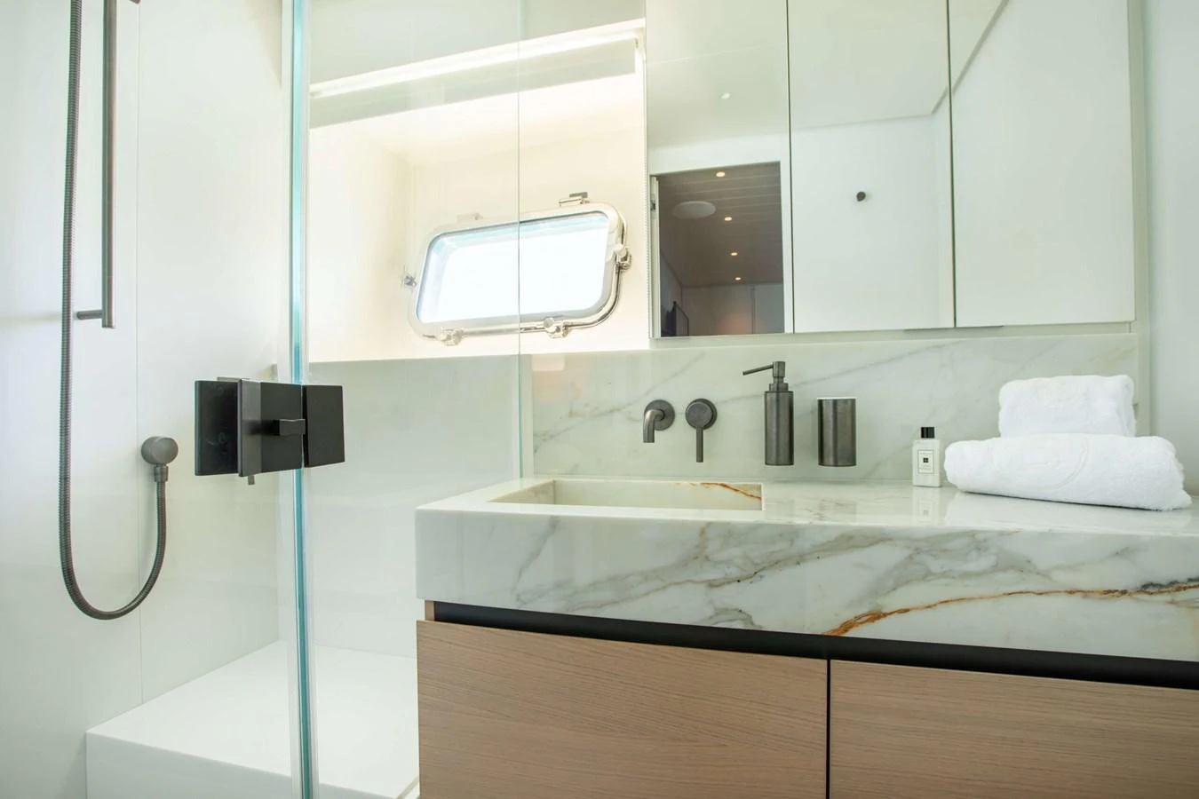 a bathroom with a sink and a mirror aboard 2020 BLUEGAME BGX70 #02 Yacht for Sale