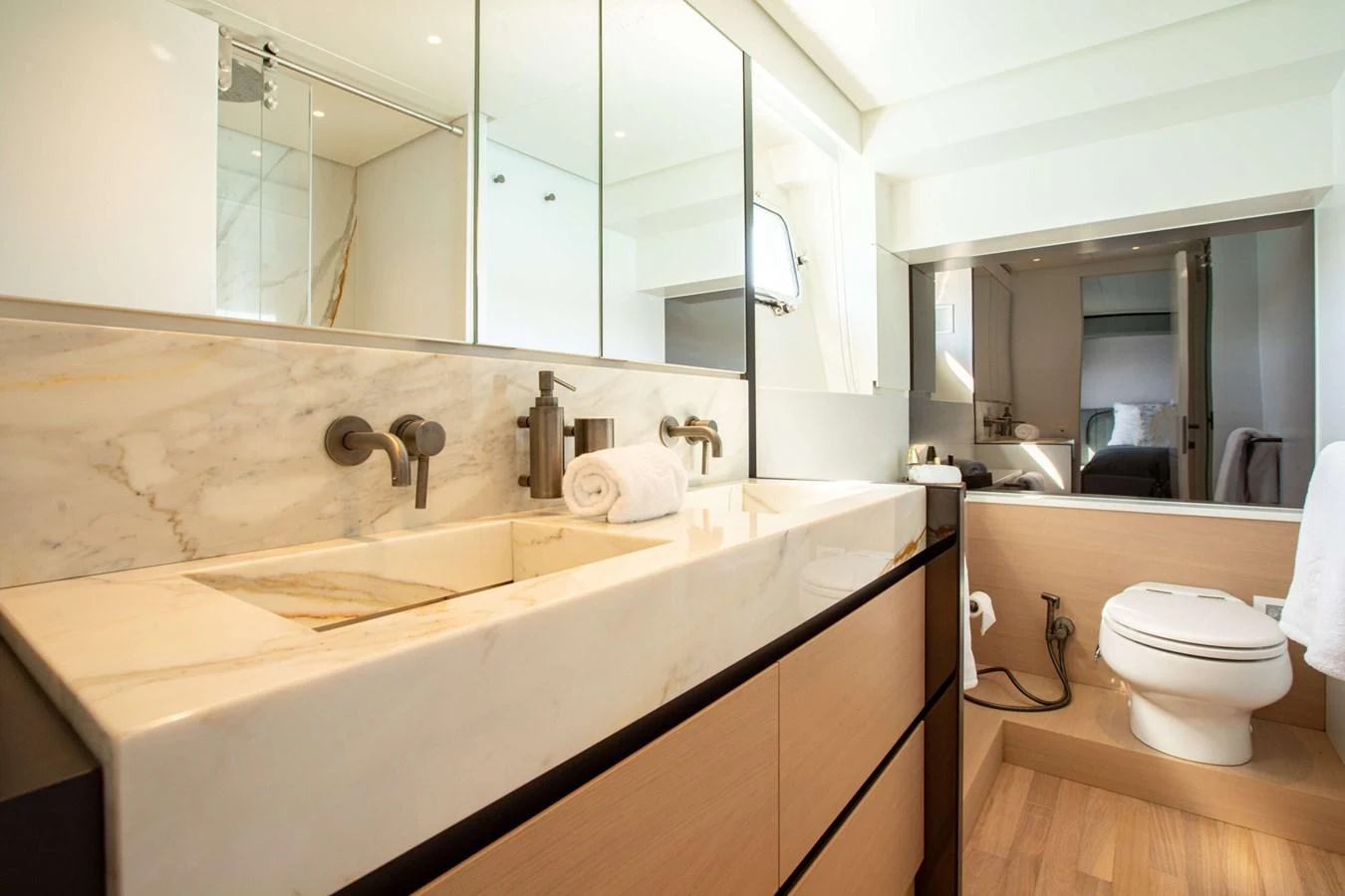 a bathroom with a large mirror aboard 2020 BLUEGAME BGX70 #02 Yacht for Sale