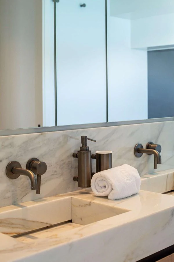 a bathroom with a large mirror aboard 2020 BLUEGAME BGX70 #02 Yacht for Sale