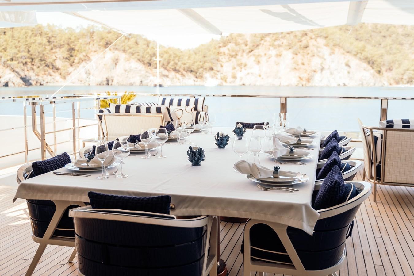 a table set for a dinner party aboard ALULIM Yacht for Sale