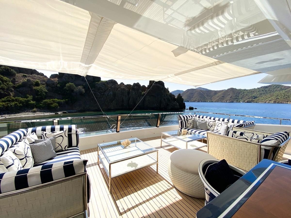 a room with a view of the ocean and mountains aboard ALULIM Yacht for Sale