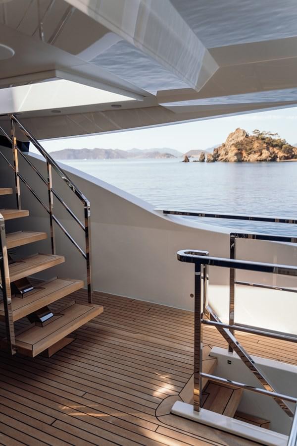 a wooden staircase leading to a large body of water aboard ALULIM Yacht for Sale