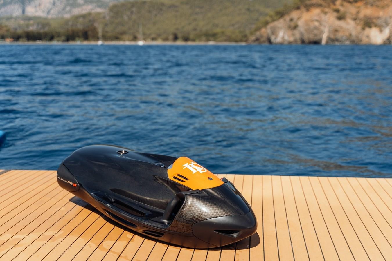 a pair of sunglasses on a deck overlooking a body of water aboard ALULIM Yacht for Sale