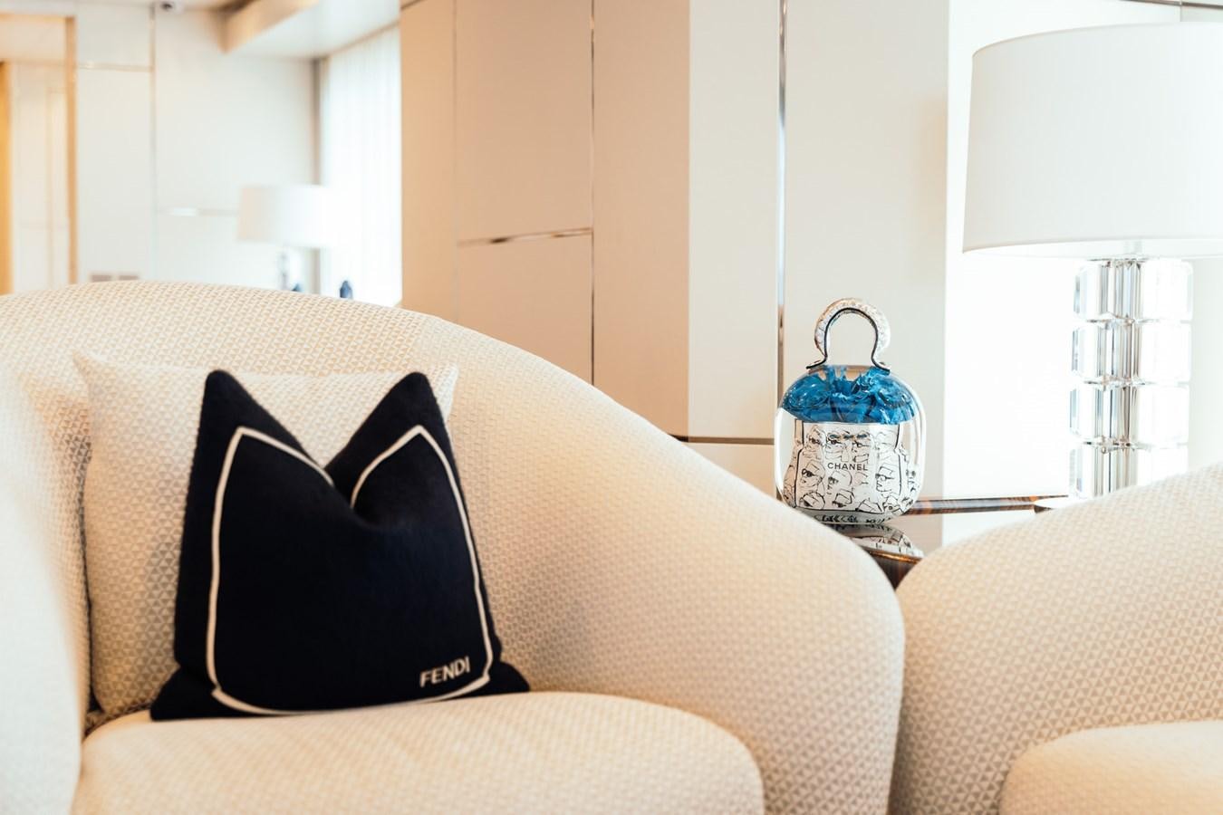 a bottle of water on a couch aboard ALULIM Yacht for Sale