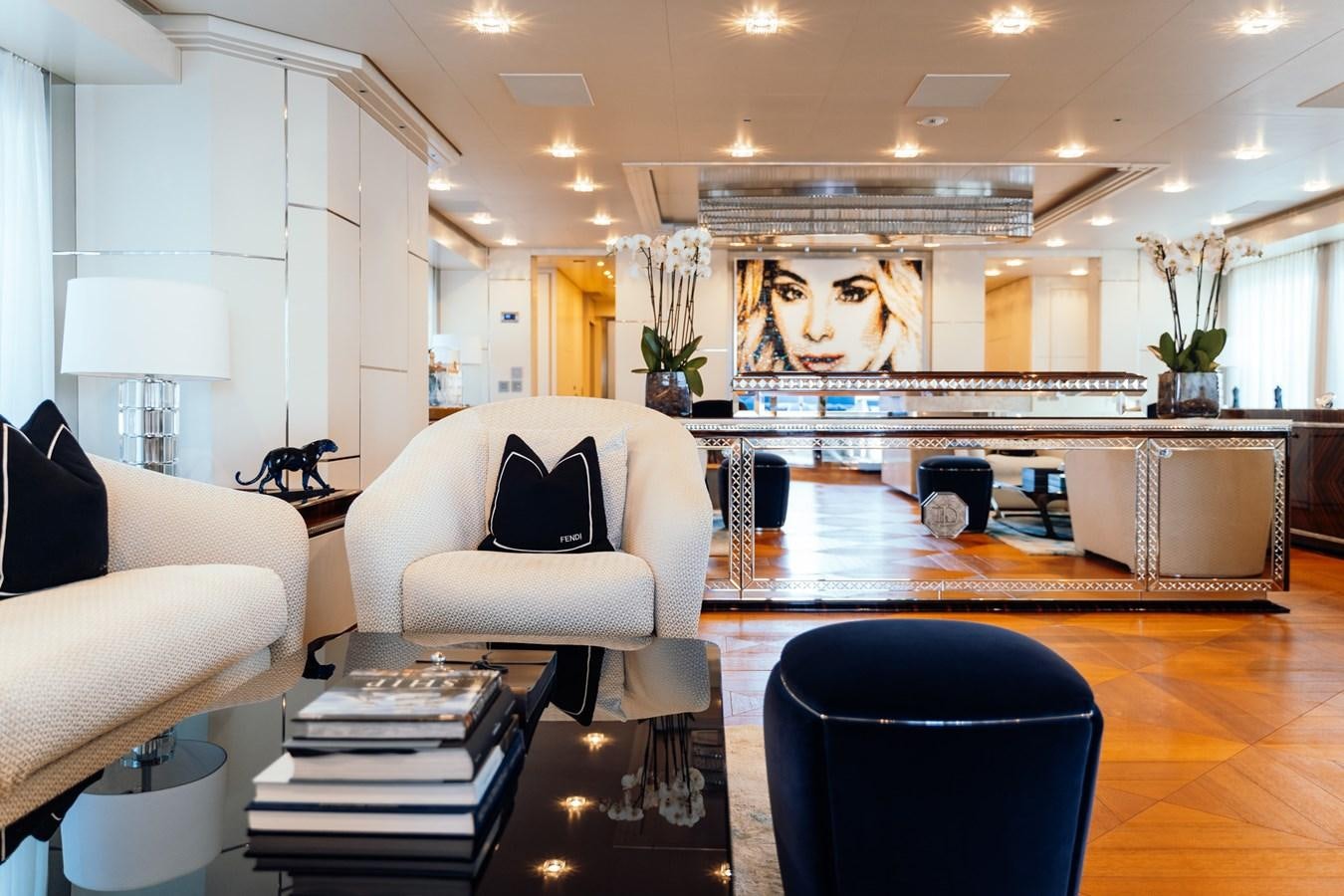 a large living room with a large kitchen and dining area aboard ALULIM Yacht for Sale