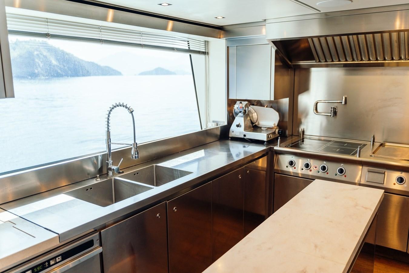 a kitchen with a large window aboard ALULIM Yacht for Sale