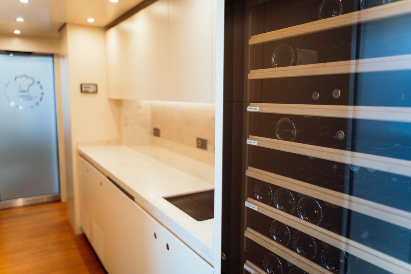 a kitchen with a blue door aboard ALULIM Yacht for Sale