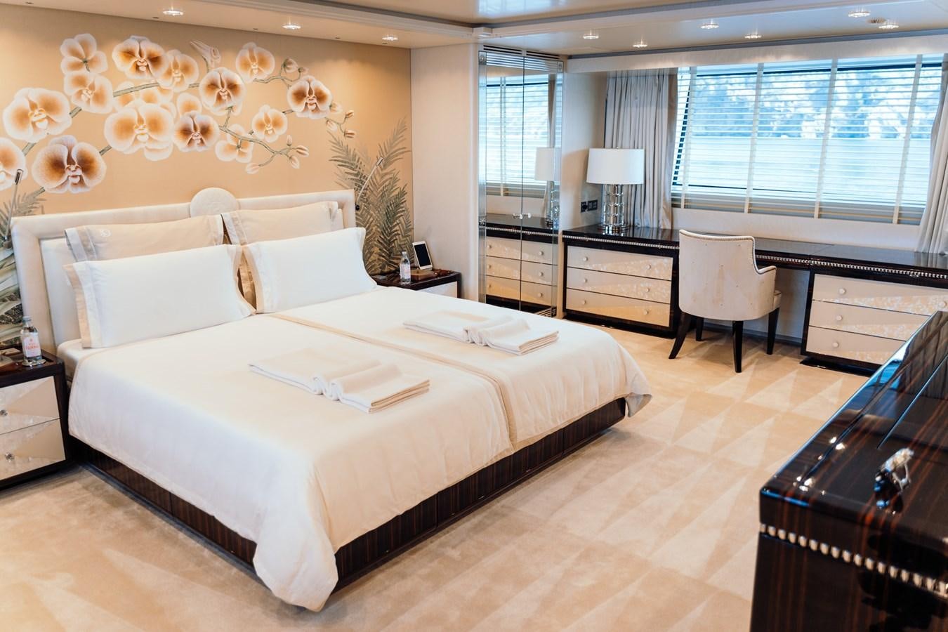 a bedroom with a large bed aboard ALULIM Yacht for Sale