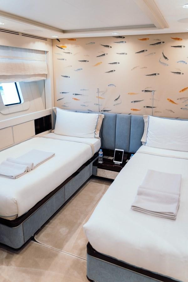a room with a bed and a desk aboard ALULIM Yacht for Sale