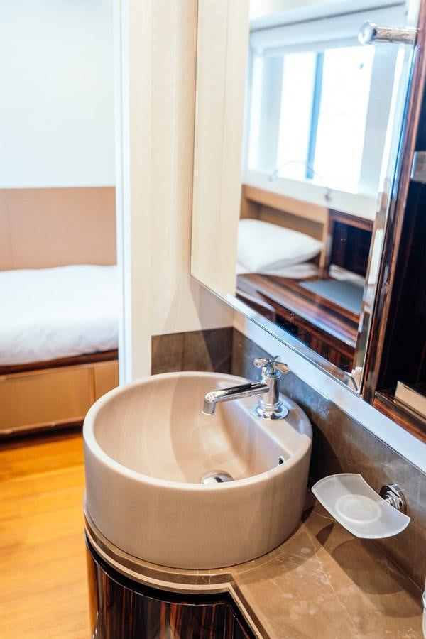 a bathroom with a tub sink and mirror aboard ALULIM Yacht for Sale