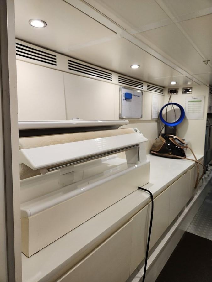 a white cabinet with a blue bucket on it aboard ALULIM Yacht for Sale