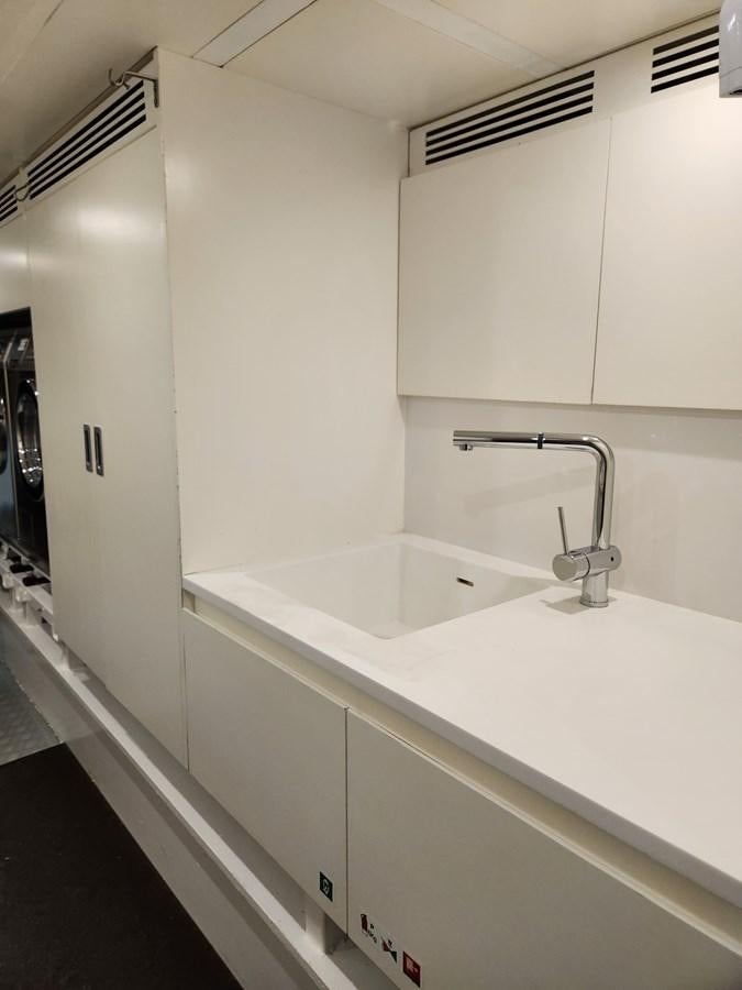 a white bathroom with a sink aboard ALULIM Yacht for Sale