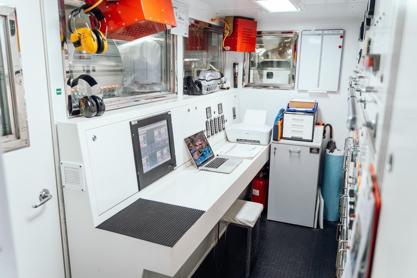 a room with a white counter and a laptop on a desk aboard ALULIM Yacht for Sale