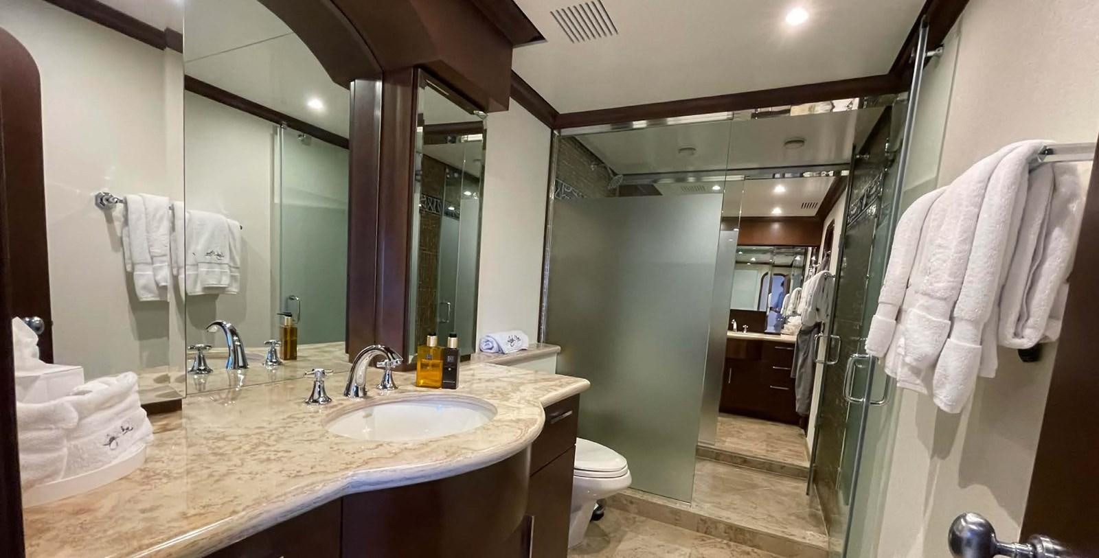 a bathroom with a large mirror aboard LADY NORA Yacht for Sale