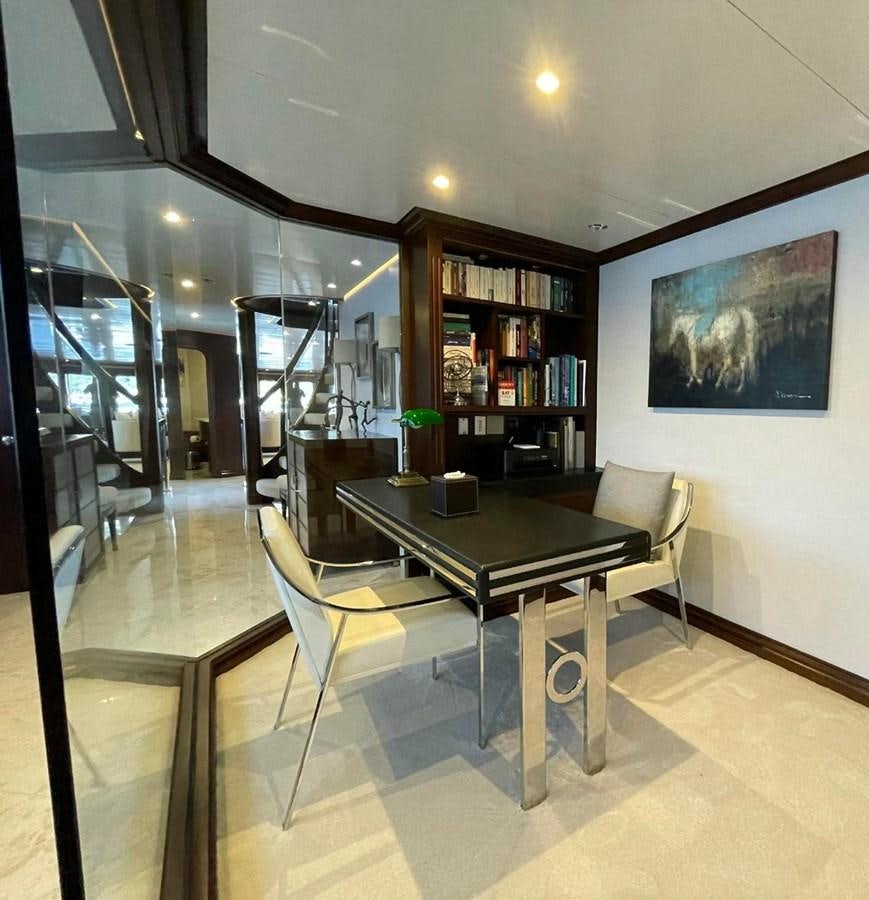a room with a table and chairs aboard LADY NORA Yacht for Sale