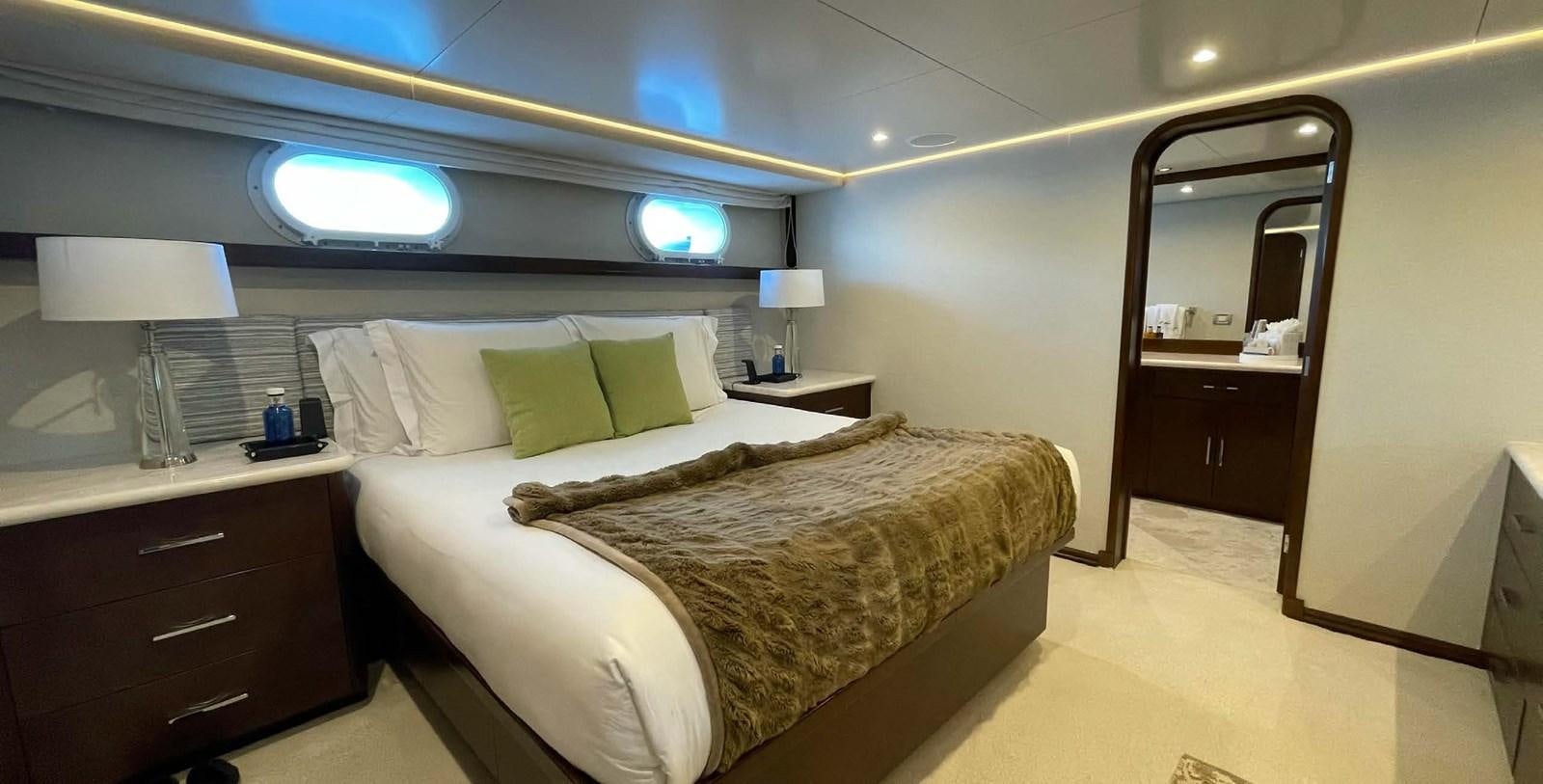 a bedroom with a bed and a mirror aboard LADY NORA Yacht for Sale