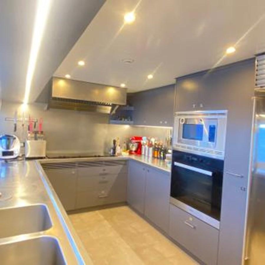 a kitchen with a microwave oven and a refrigerator aboard LADY NORA Yacht for Sale