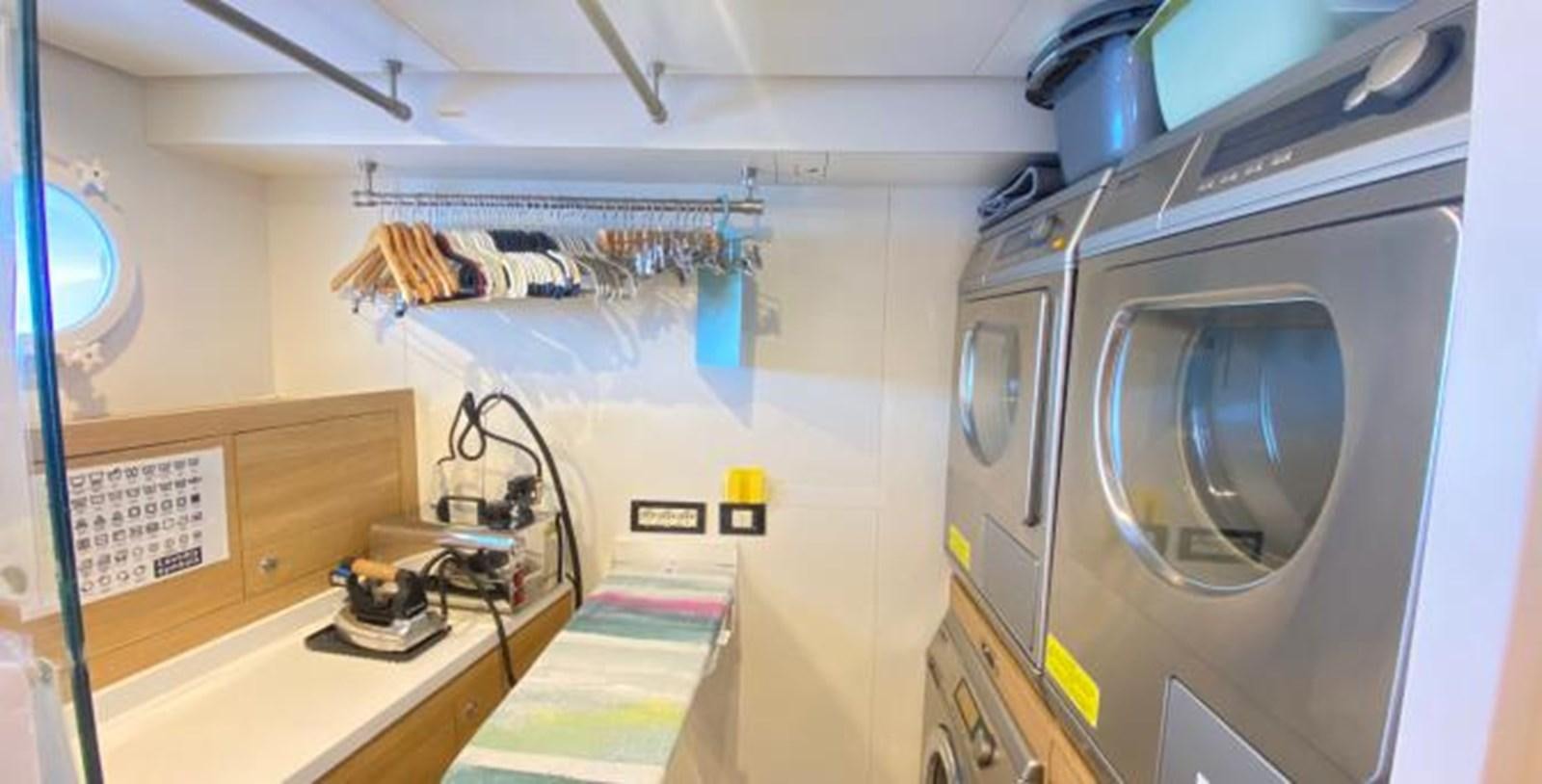 a room with a machine and a sink aboard LADY NORA Yacht for Sale