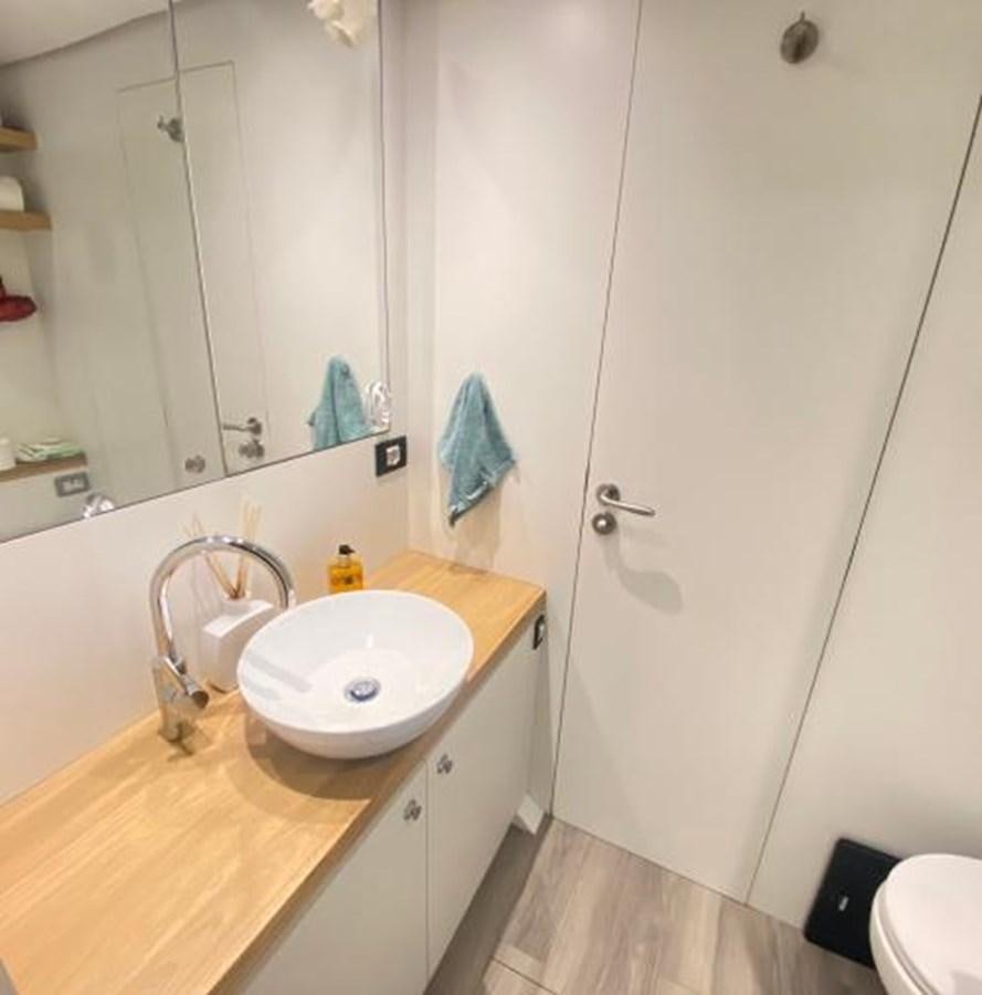 a bathroom with a sink and a mirror aboard LADY NORA Yacht for Sale