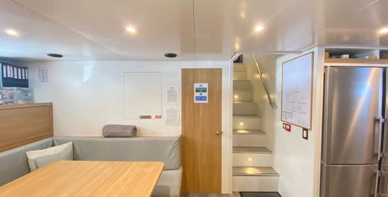 a room with a couch and a refrigerator aboard LADY NORA Yacht for Sale