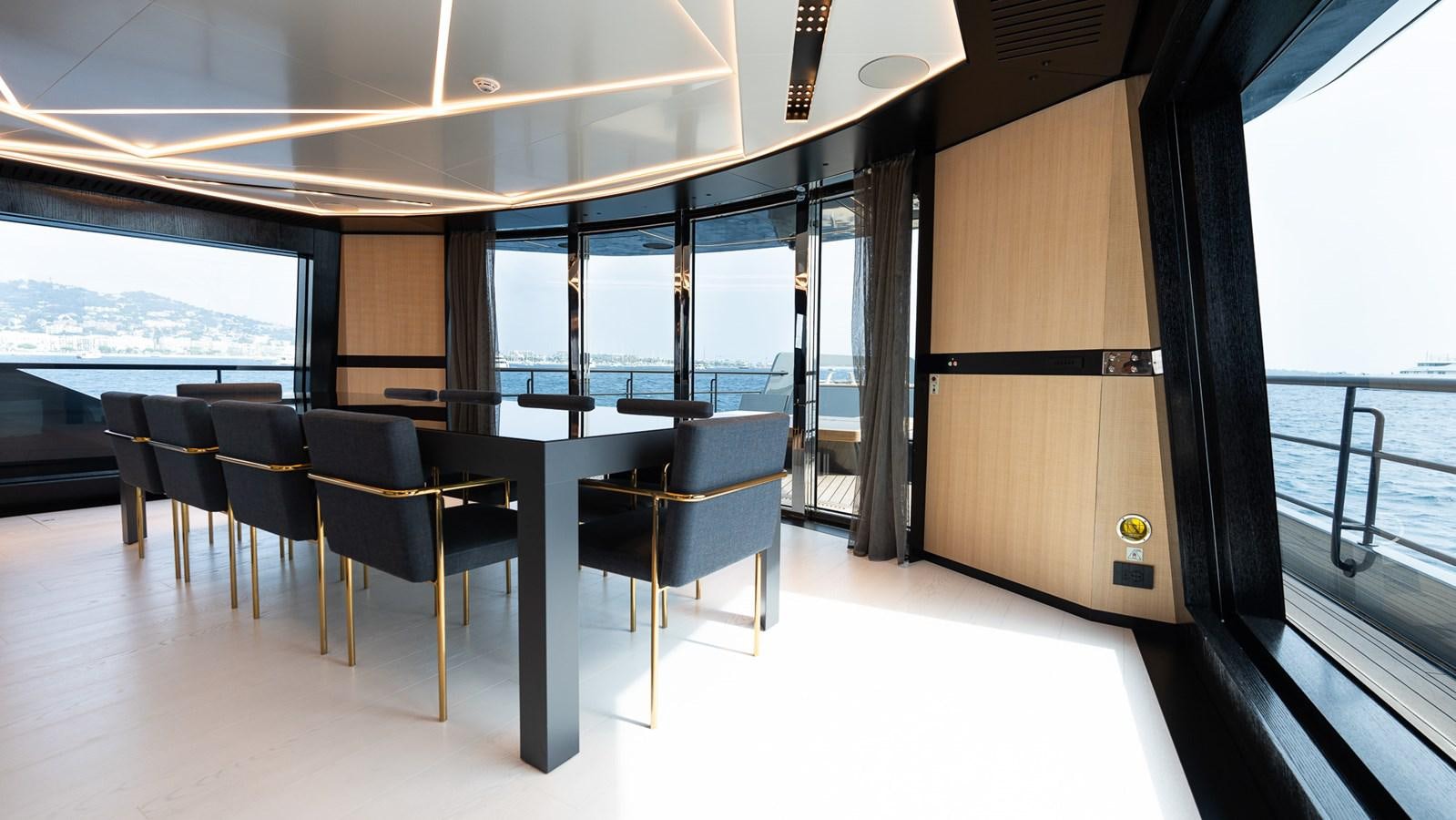 a room with a table and chairs aboard LASTOCHKA Yacht for Sale