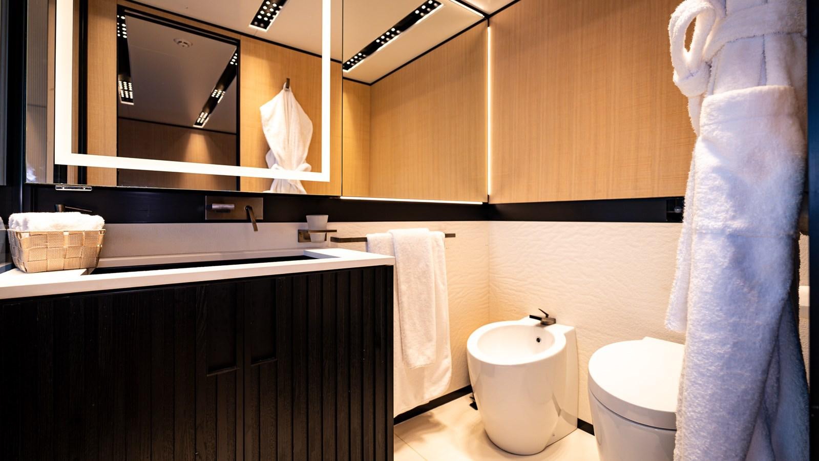 a bathroom with a mirror and a toilet aboard LASTOCHKA Yacht for Sale