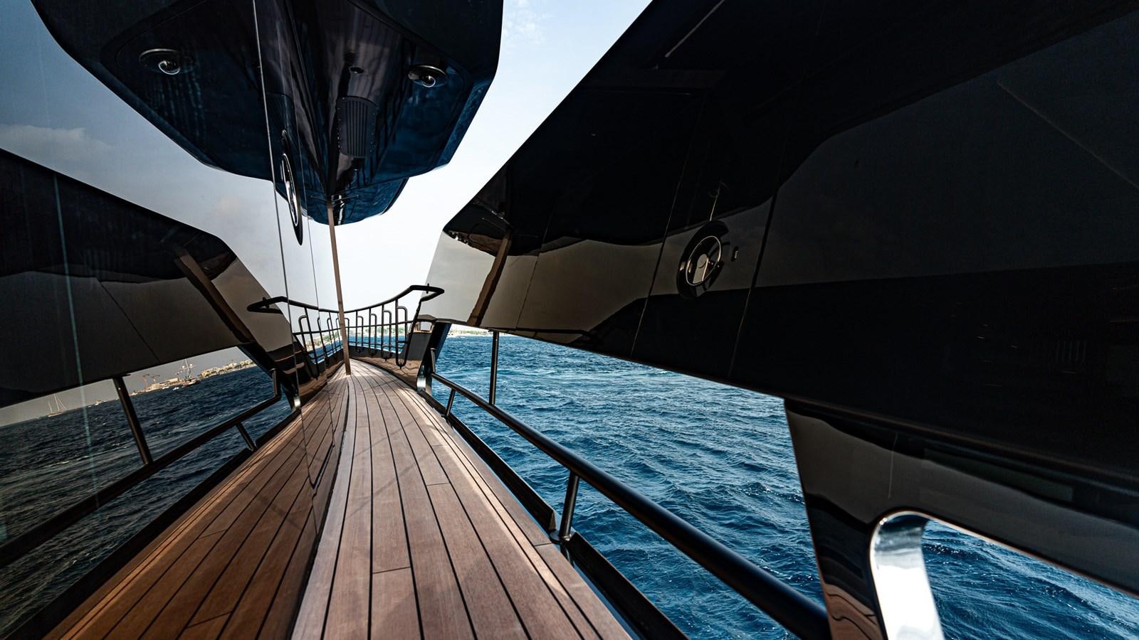 a deck with a large umbrella aboard LASTOCHKA Yacht for Sale