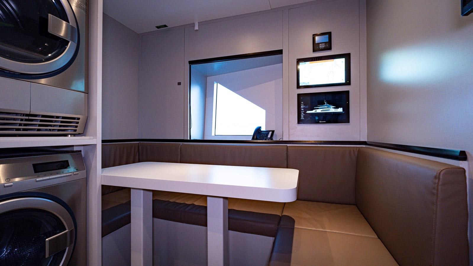 a room with a table and tv aboard LASTOCHKA Yacht for Sale